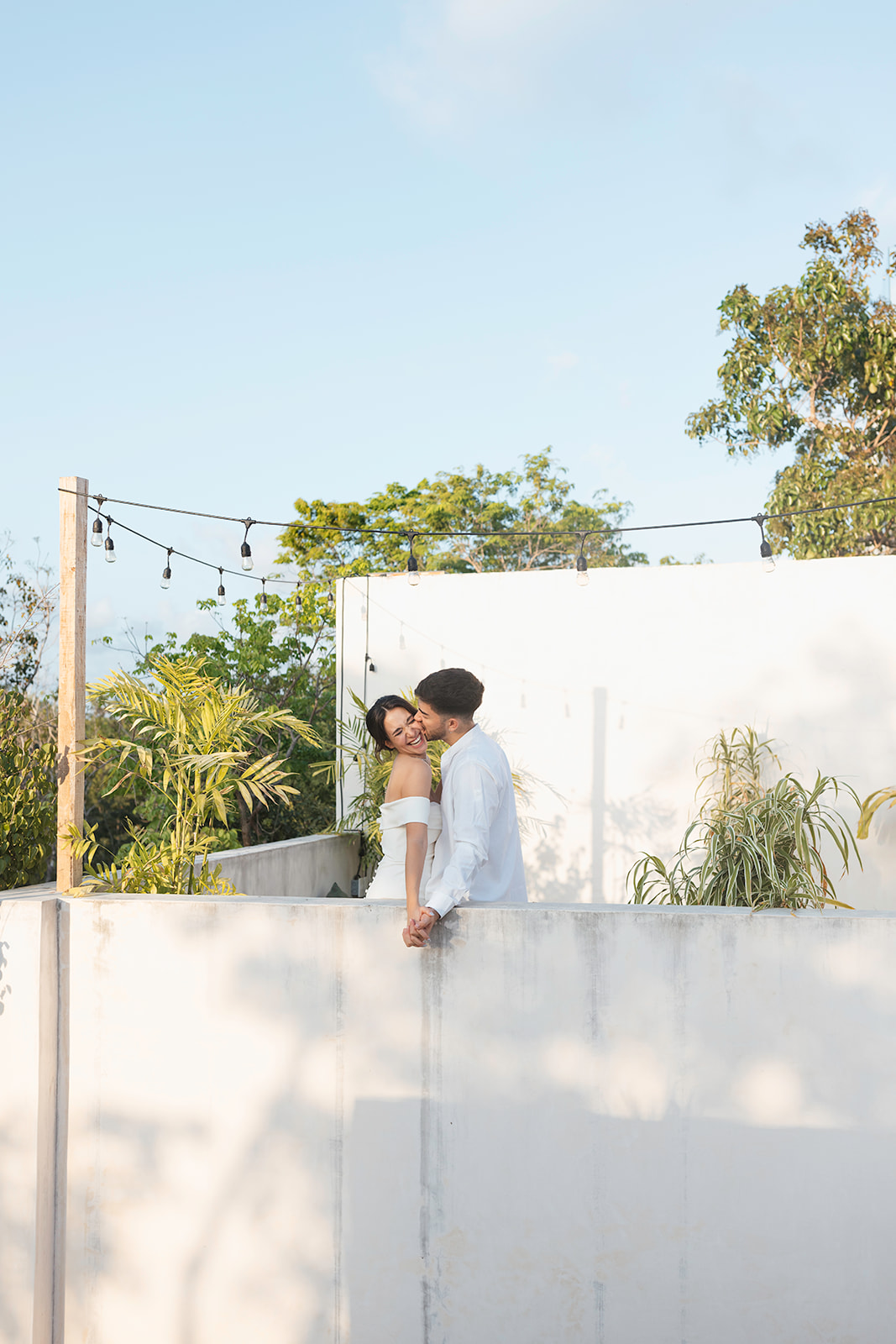 beautiful couple pose together in a tropical destination 