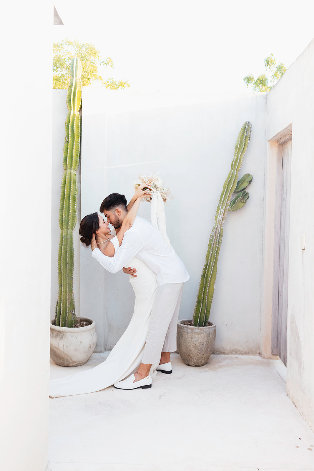 beautiful couple pose together in a tropical destination 